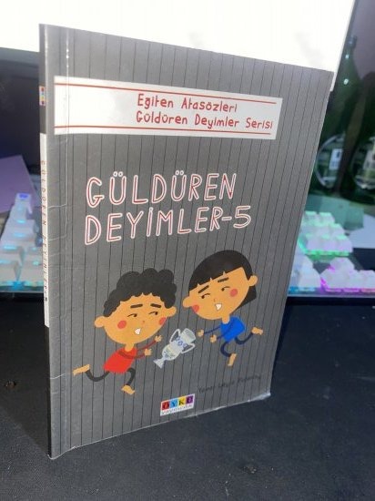 GÜLDÜREN DEYİMLER 5 - Eğiten Atasözleri Güldüren Deyimler Serisi - ZAFER İŞÇİ kitap kapağı